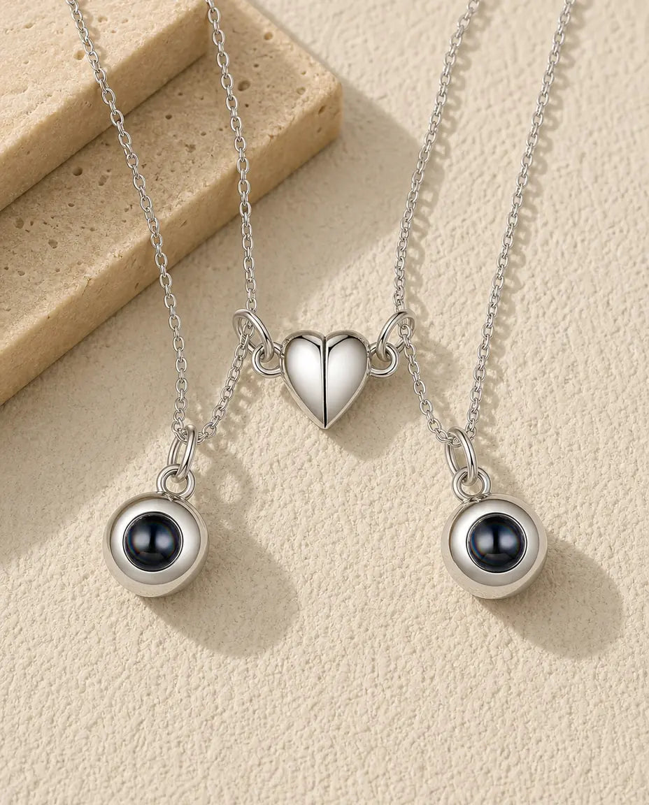 Personalised magnetic half heart photo projection couple necklace set of two in silver, flat lay