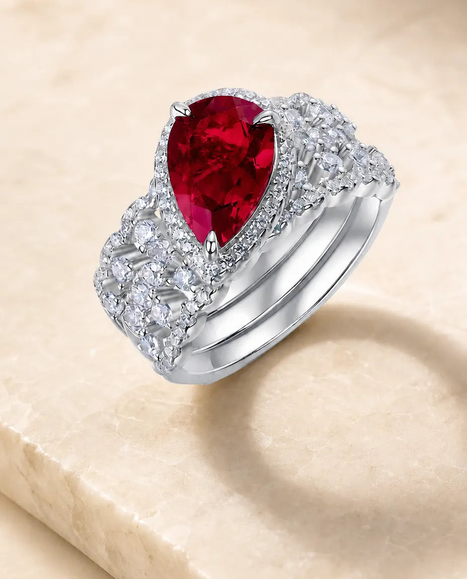 lab-created ruby pear-cut 2-piece halo bridal set ring in sterling silver