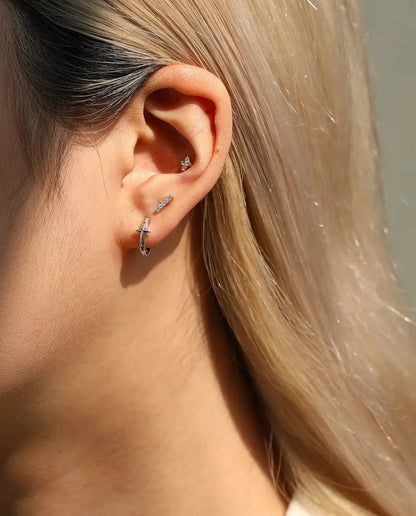Moissanite Bar Stud Earrings in 925 Sterling Silver - worn on a model, wider view of ear and neck