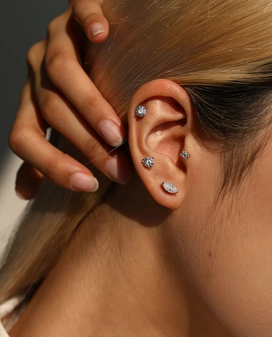 Four-Stone Moissanite Clover Stud Earrings in 925 Sterling Silver - worn on a model with her hand at the back of her head