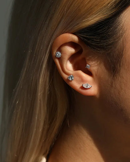 Four-Stone Moissanite Clover Stud Earrings in 925 Sterling Silver - worn together with other studs in the same ear