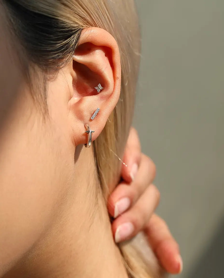 Four-Stone Moissanite Clover Stud Earrings in 925 Sterling Silver - worn on a model tucking her hair behind her ear