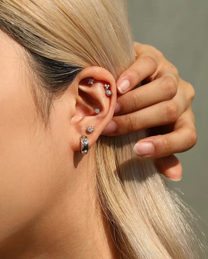 Four-Stone Moissanite Clover Stud Earrings in 925 Sterling Silver - worn on a model holding her hair back, side view