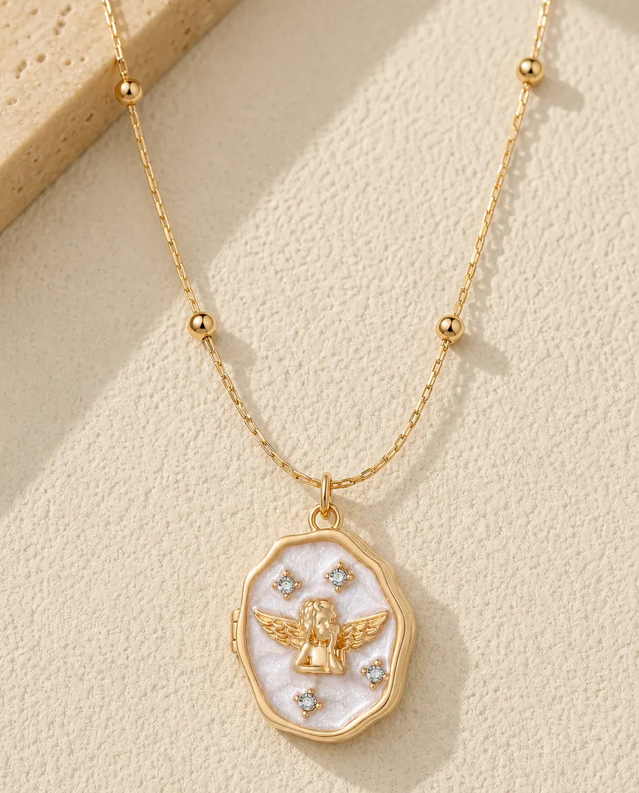 Personalised guardian angel mother of pearl photo locket necklace in gold, closed, flat lay