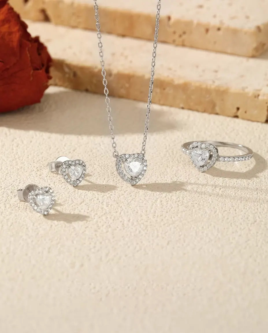 Heart Moissanite Jewellery Set in 925 Sterling Silver - the full set on a cream stone surface