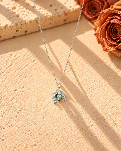 Heart Moss Agate Branch Necklace in 925 Sterling Silver - the whole necklace laid out in a long V on a cream textured surface