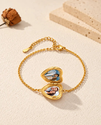 Open heart locket bracelet with two photos, seen from a low angle