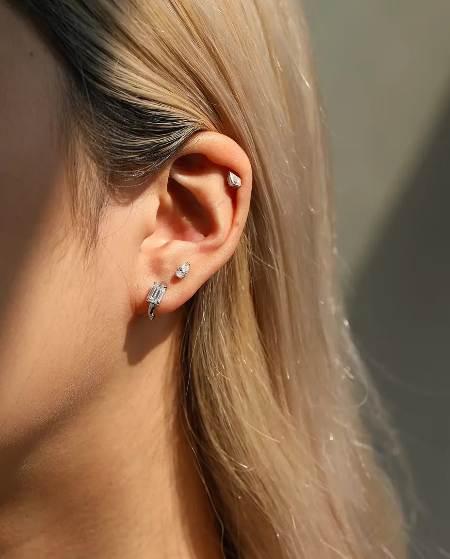 Kite Cut Moissanite Stud Earrings in 925 Sterling Silver - worn in an ear stack, profile view