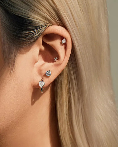 Kite Cut Moissanite Stud Earrings in 925 Sterling Silver - worn together with other studs in the same ear