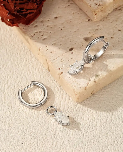 Marquise Moissanite Charm Huggie Hoop Earrings in 925 Sterling Silver - one hoop opened with its marquise charm beside it, the other closed