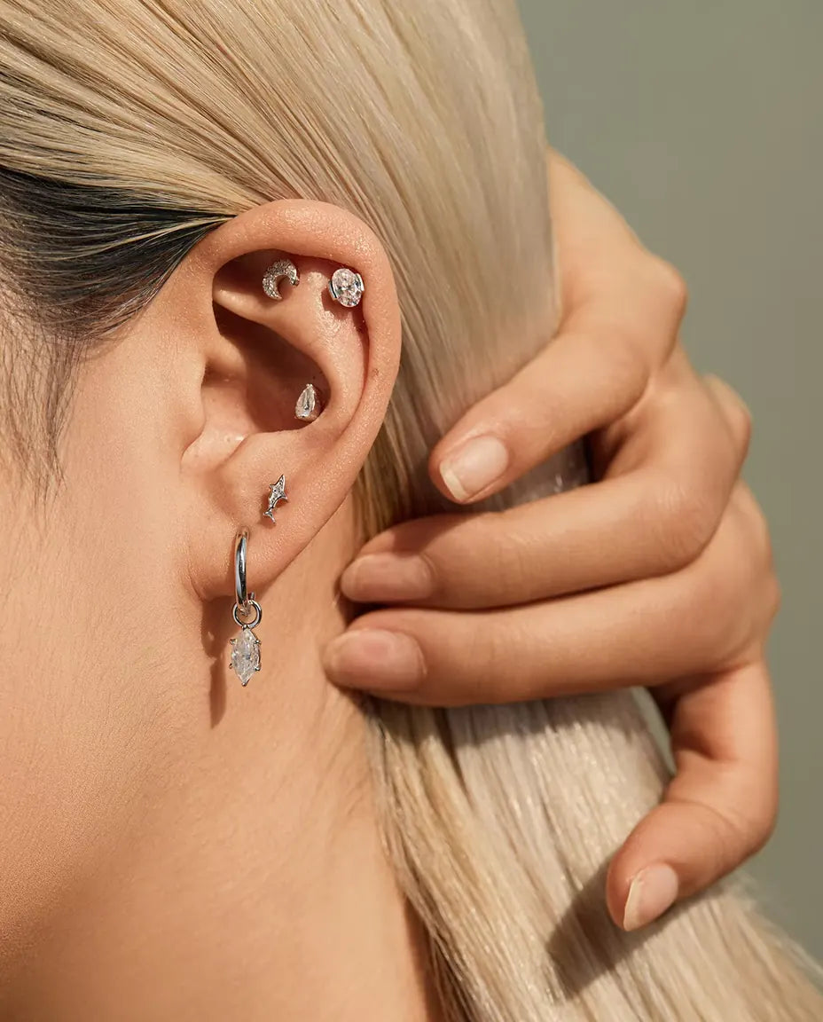 Marquise Moissanite Charm Huggie Hoop Earrings in 925 Sterling Silver - worn on a model tucking her hair behind her ear