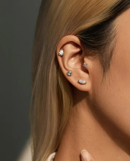 Marquise Moissanite Stud Earrings in 925 Sterling Silver - worn on a model with her hand at her neck