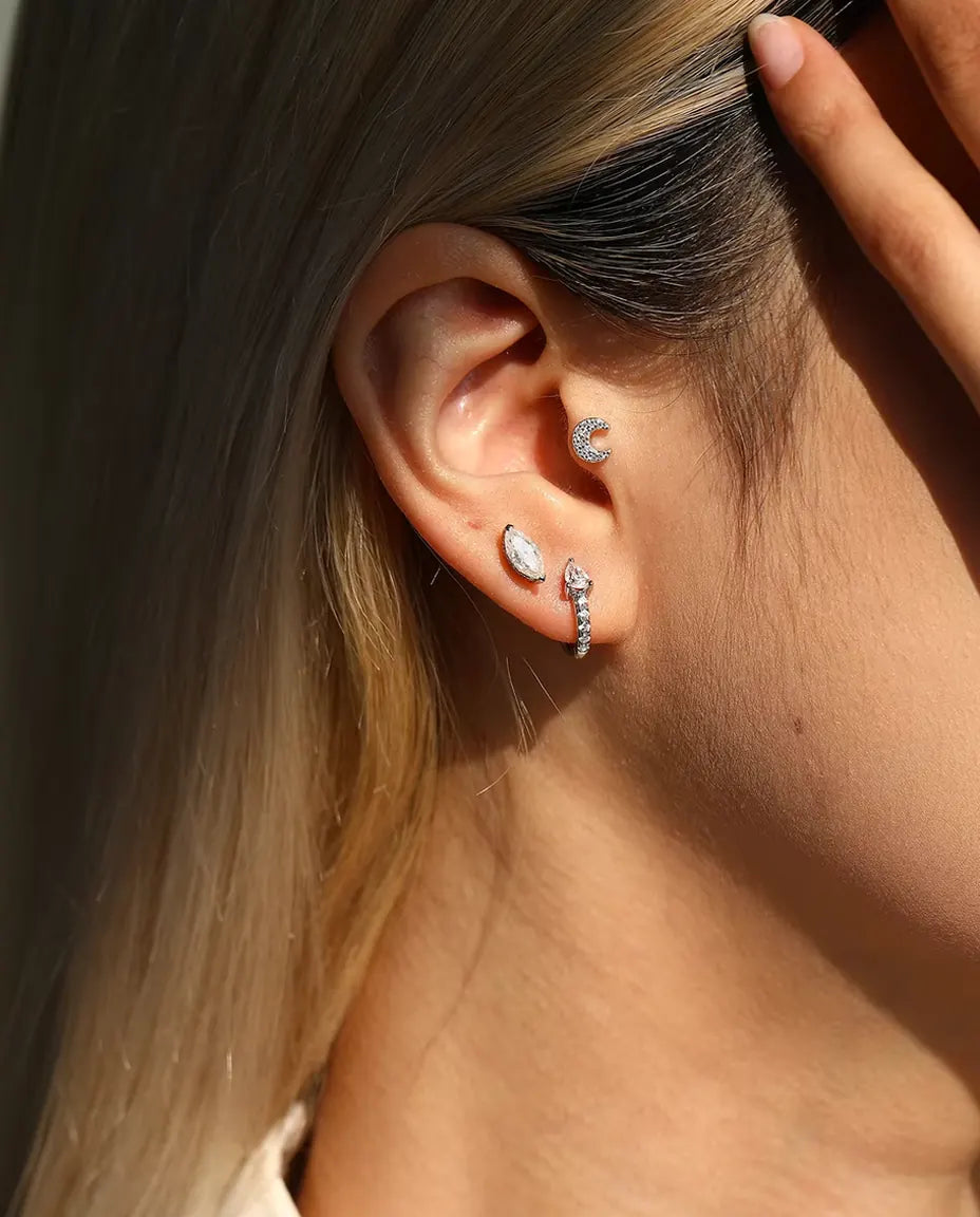 Marquise Moissanite Stud Earrings in 925 Sterling Silver - worn on a model tucking her hair behind her ear
