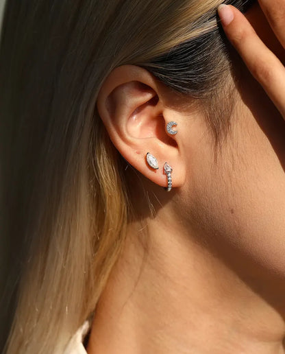 Marquise Moissanite Stud Earrings in 925 Sterling Silver - worn on a model tucking her hair behind her ear