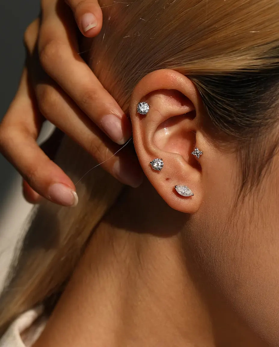Marquise Moissanite Stud Earrings in 925 Sterling Silver - worn on a model holding her hair back, side view