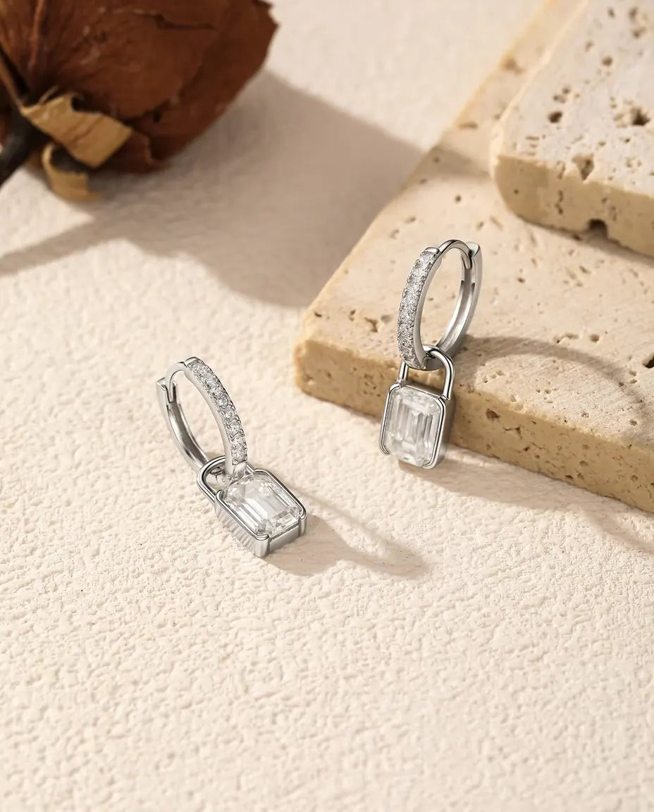 Moissanite Padlock Hoop Earrings in 925 Sterling Silver - arranged by a travertine slab