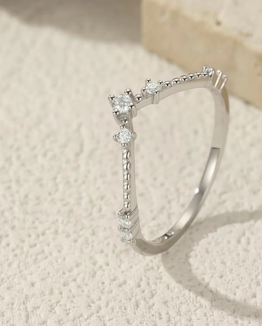 Moissanite Wedding Band - displayed on a travertine block