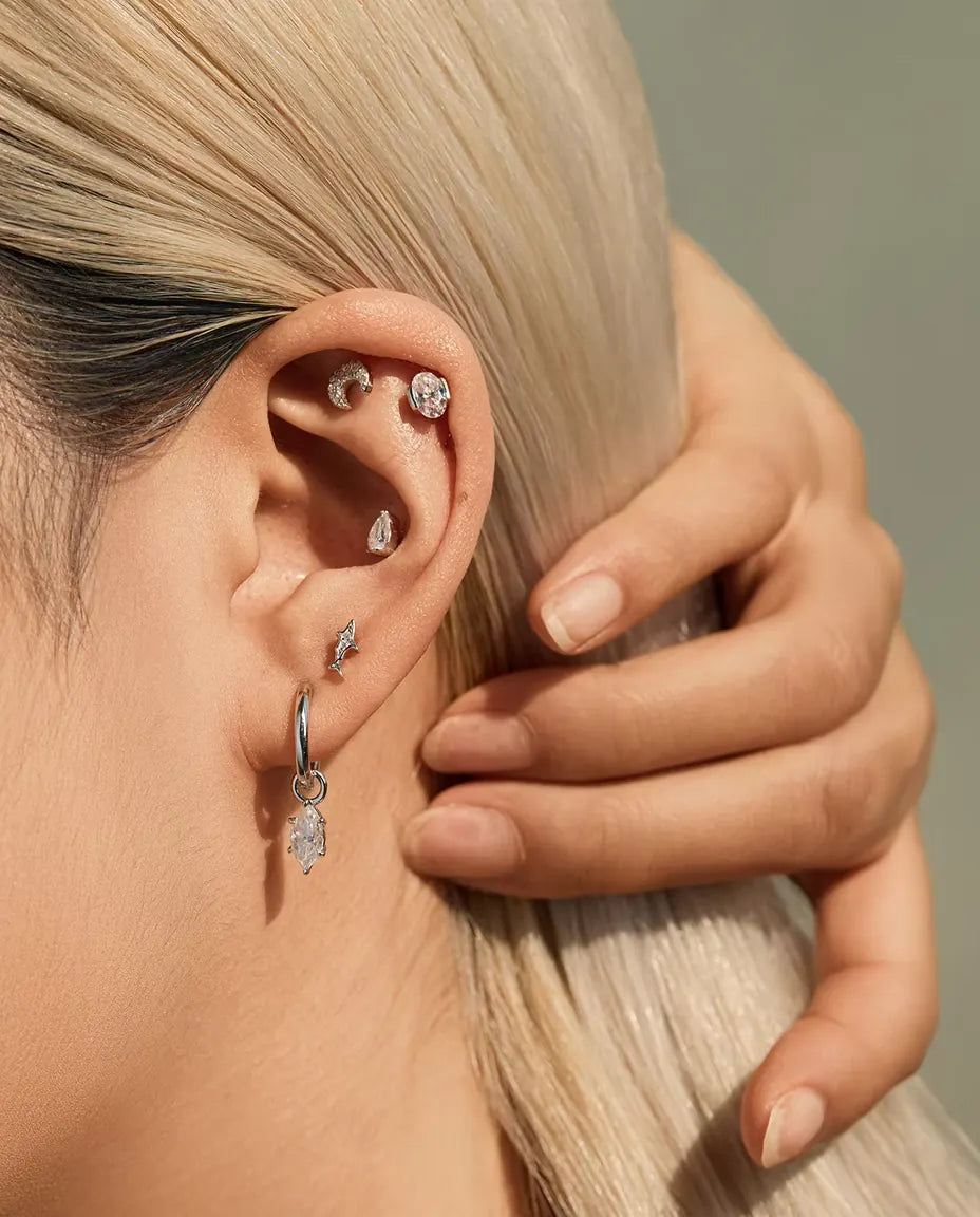 Shark Stud Earrings in 925 Sterling Silver with Moissanite - worn on a model with her hand at the back of her head