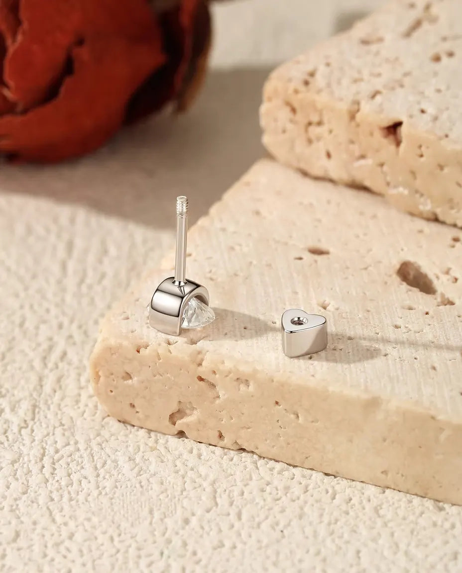 Oval Moissanite Stud Earrings in 925 Sterling Silver - with the heart-shaped back taken off and set beside it