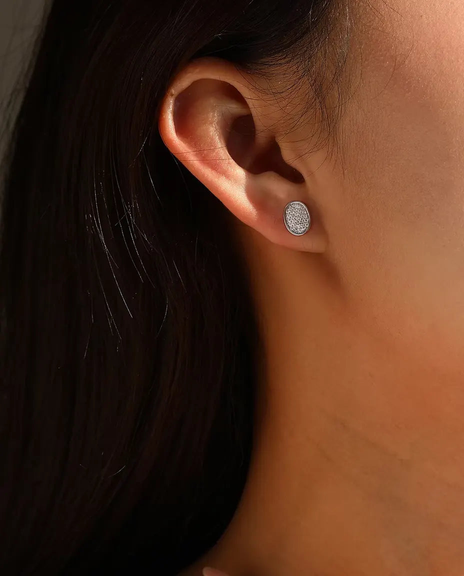 Oval Pave Moissanite Stud Earrings in 925 Sterling Silver - worn in an ear stack, profile view