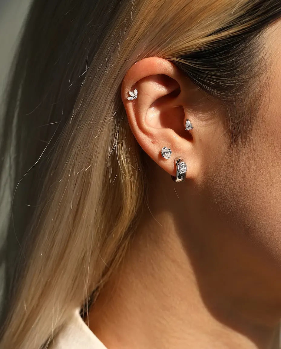 Pear Moissanite Stud Earrings in 925 Sterling Silver - worn together with other studs in the same ear