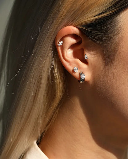 Pear Moissanite Stud Earrings in 925 Sterling Silver - worn together with other studs in the same ear