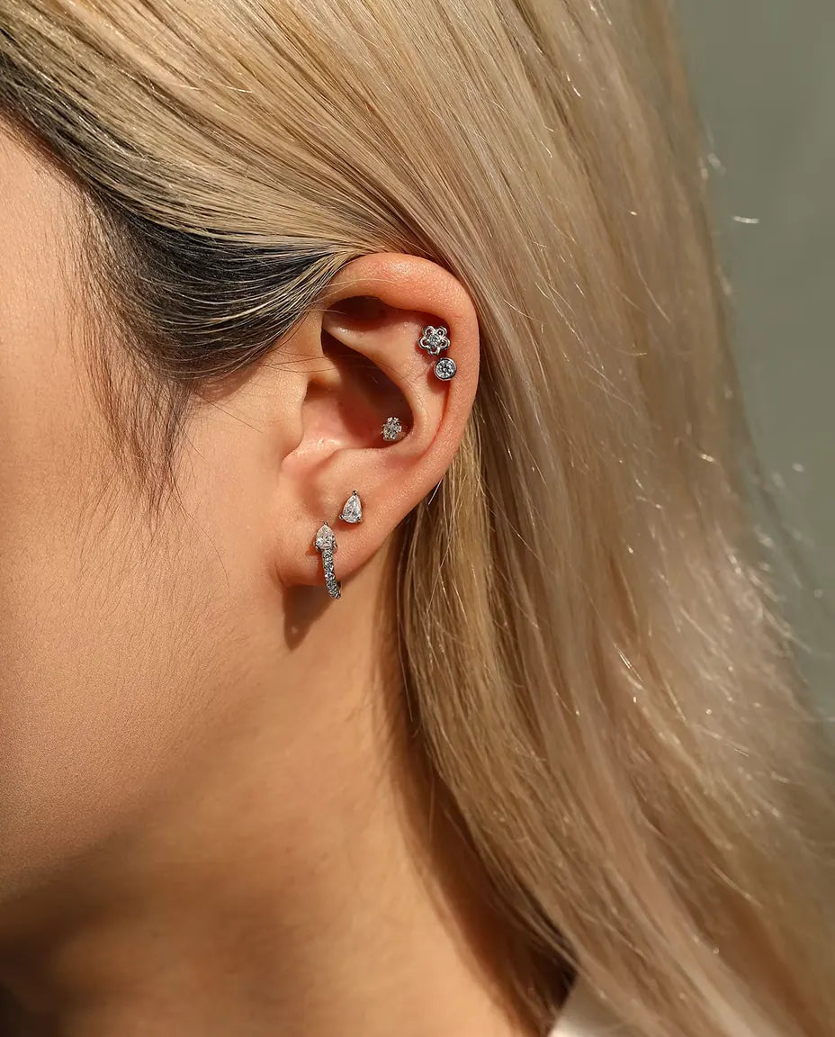 Pear Moissanite Stud Earrings in 925 Sterling Silver - worn in an ear stack, profile view