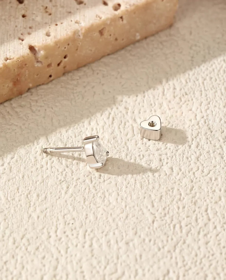 Pear Moissanite Stud Earrings in 925 Sterling Silver - with the heart-shaped back taken off and set beside it