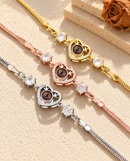 Close-up of three heart charms with tiny antlers and pave stones in each colour