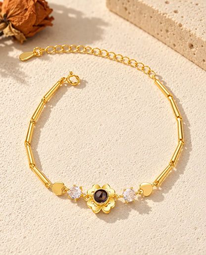 Top view of the gold tone clover flower photo projection bracelet