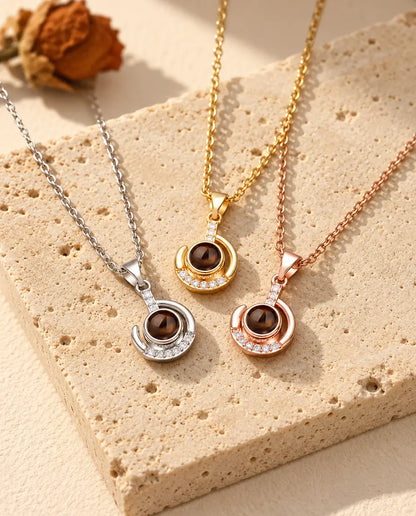 Crescent moon projection necklaces in silver tone, gold tone and rose gold tone side by side
