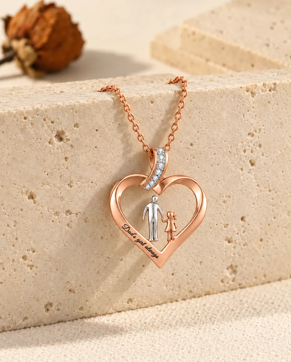 Father daughter heart necklace draped over the edge of a travertine block