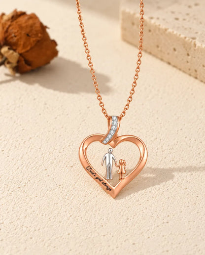 Custom engraved dad's girl heart necklace laid flat with its rose gold-tone chain