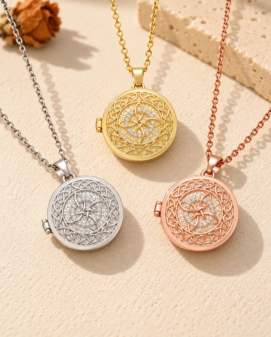 Three colours of the four-loop Celtic knot photo locket necklace arranged on plaster
