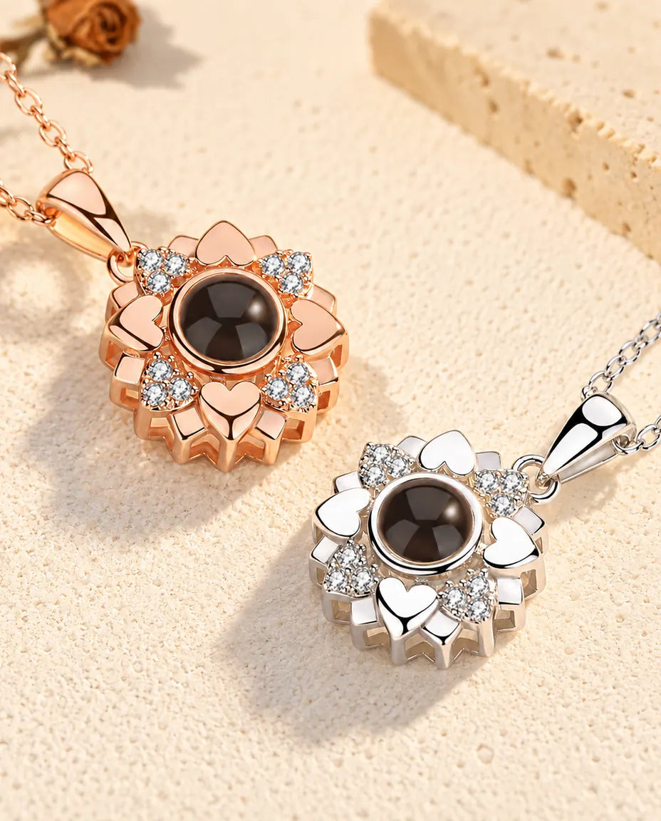 Rose gold tone and silver tone heart flower projection pendants side by side