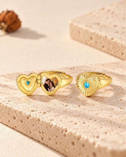 Two heart photo locket rings, one open with a photo and one closed