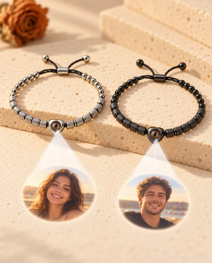 Two heart bead bracelets project two round photos, one of a smiling woman and one of a smiling man