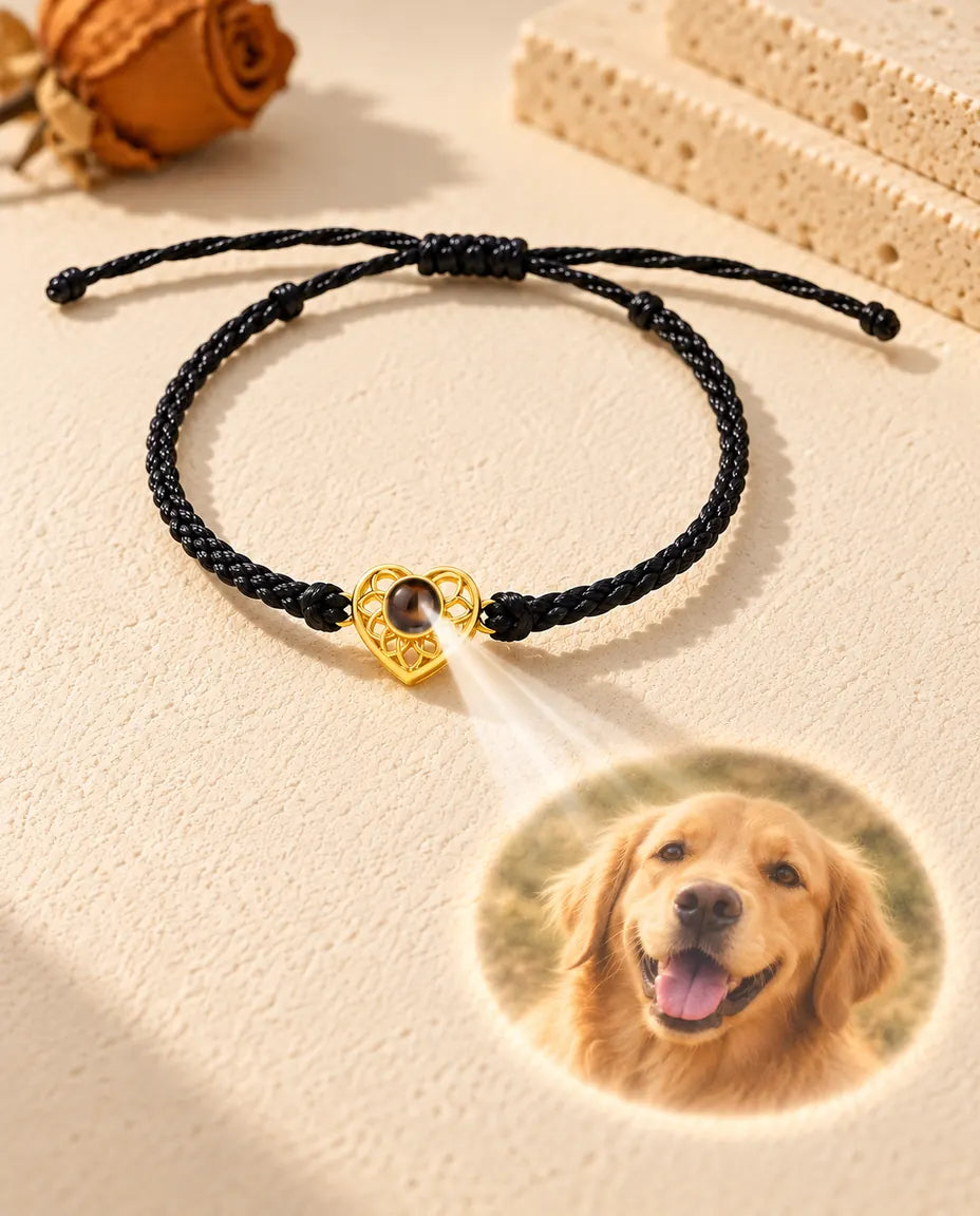 Light through the brown stone of the gold tone heart charm projects a round photo onto the plaster