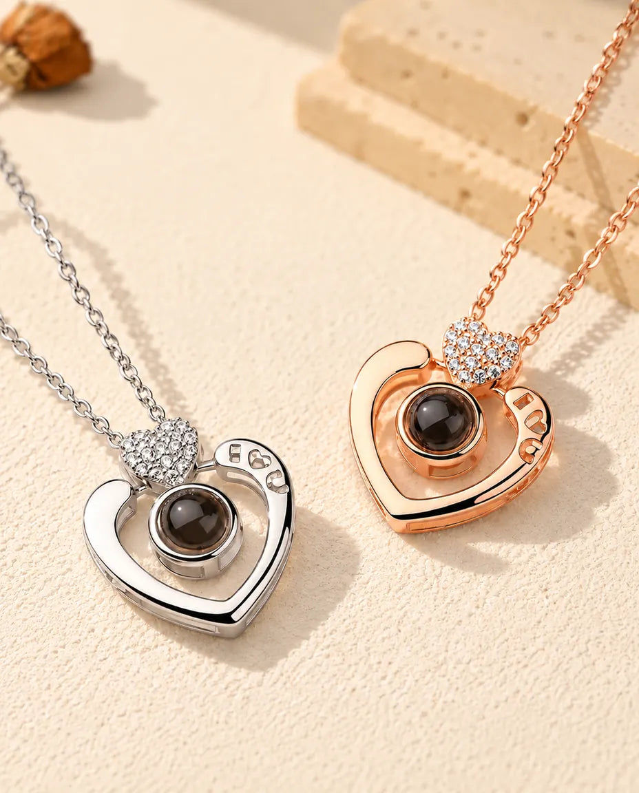 Silver tone and rose gold tone open heart projection necklaces with pave hearts side by side