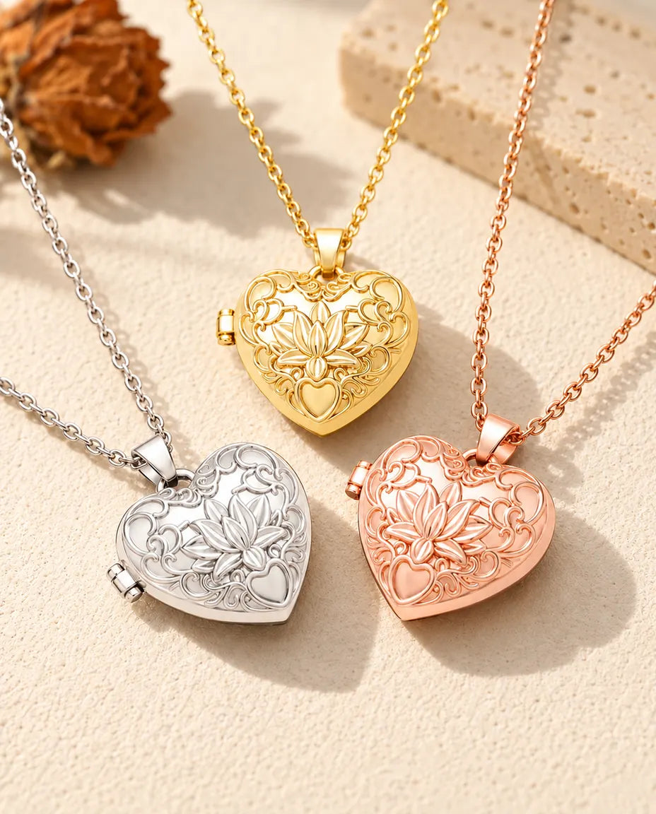 Three colours of the lotus flower heart photo locket necklace arranged on plaster