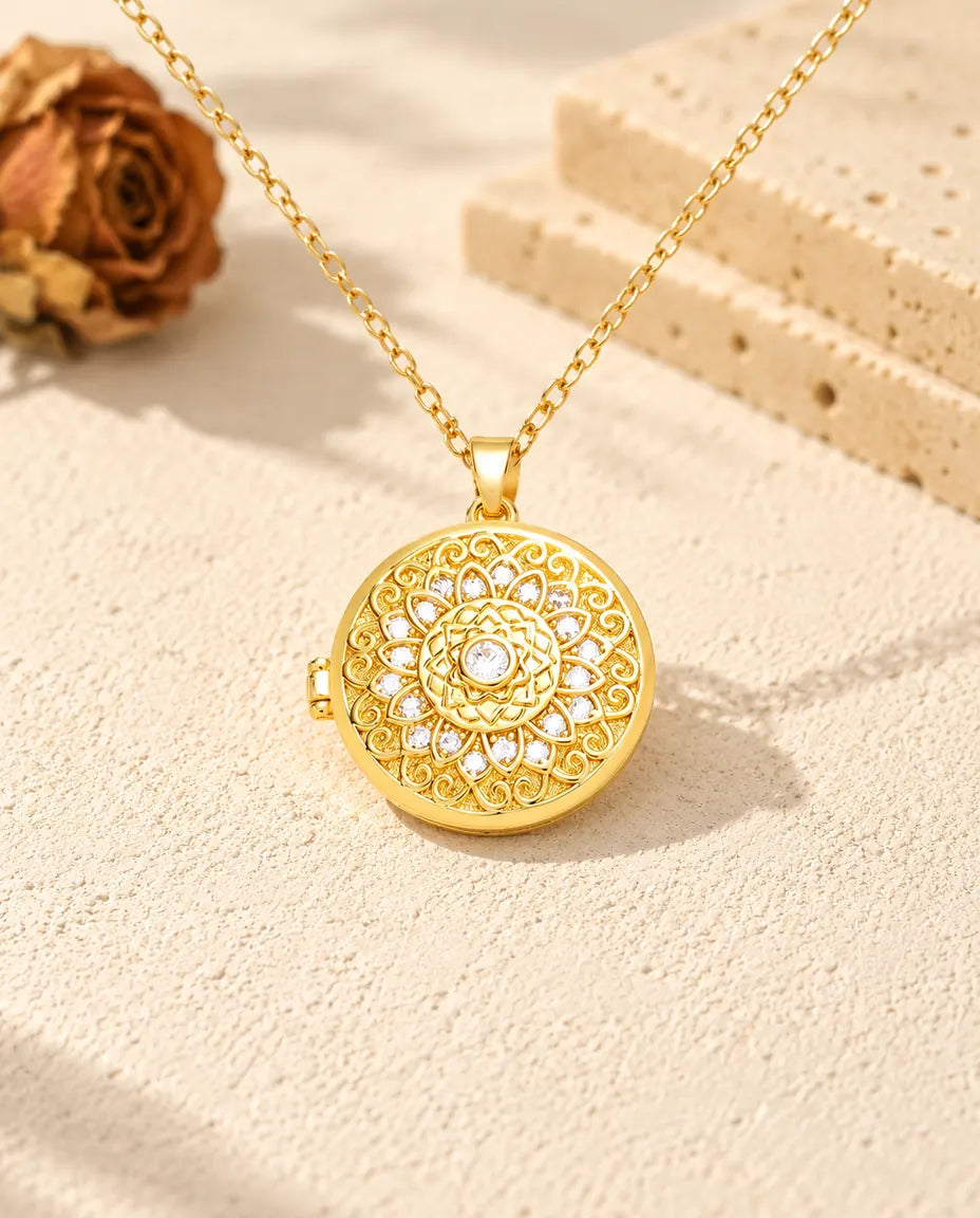 Front view of the gold tone round mandala flower locket showing the lid design and side hinge