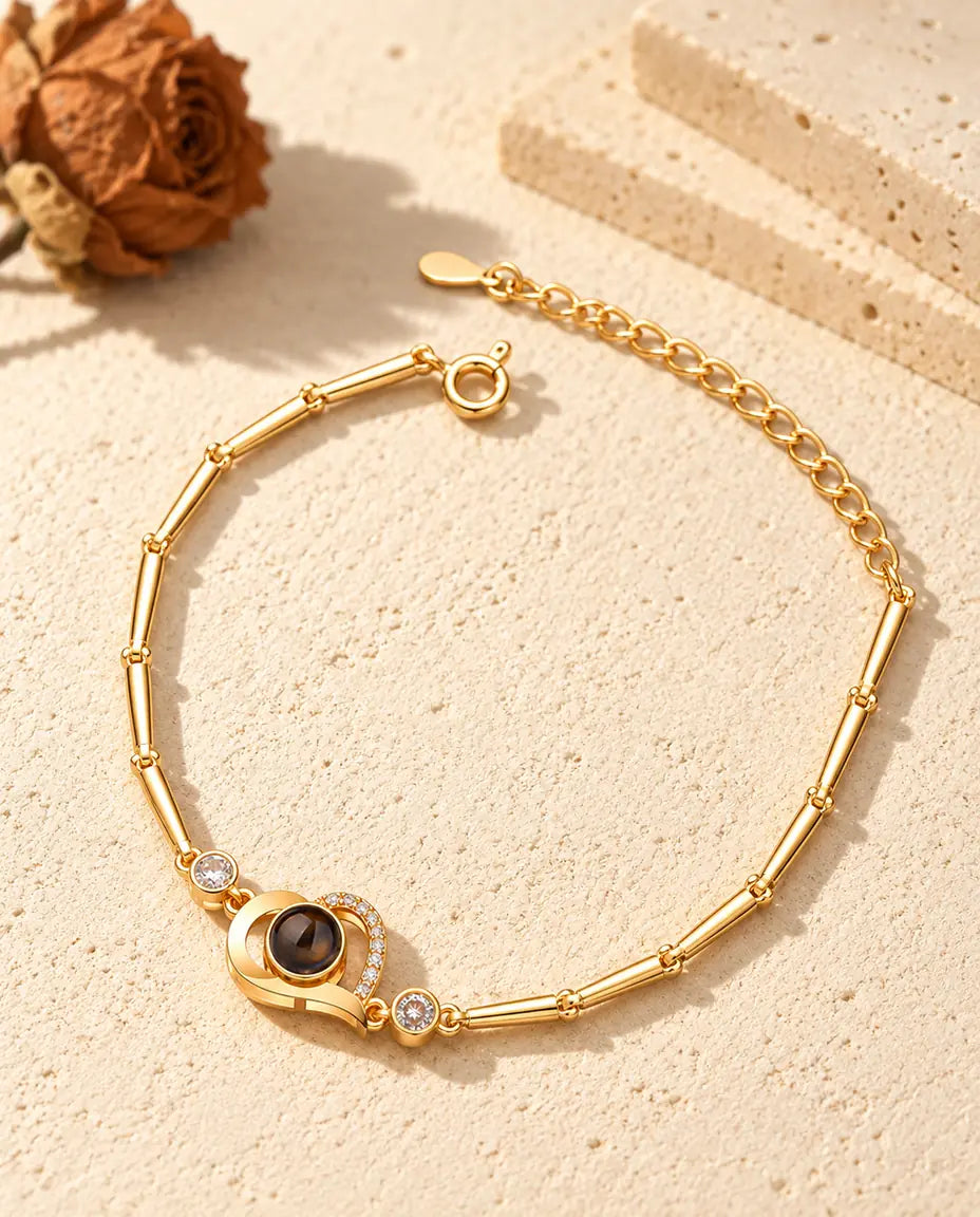 Gold tone open heart bracelet with a pave line, side stones and spring ring clasp
