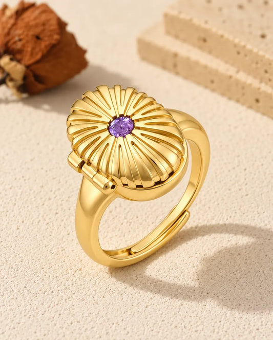 Personalised oval photo locket ring in gold tone with a purple birthstone on the fluted lid