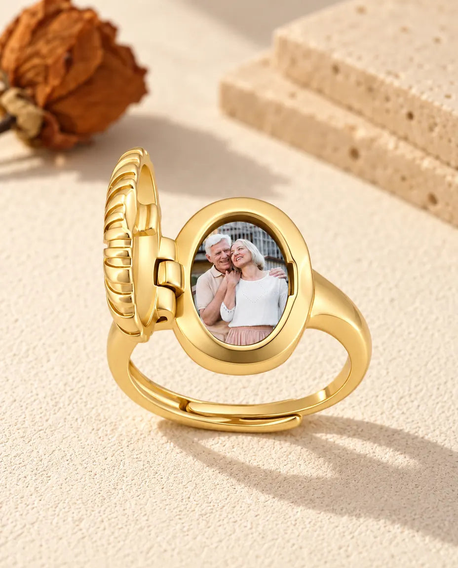Oval locket ring opened to show a printed couple photo inside the frame