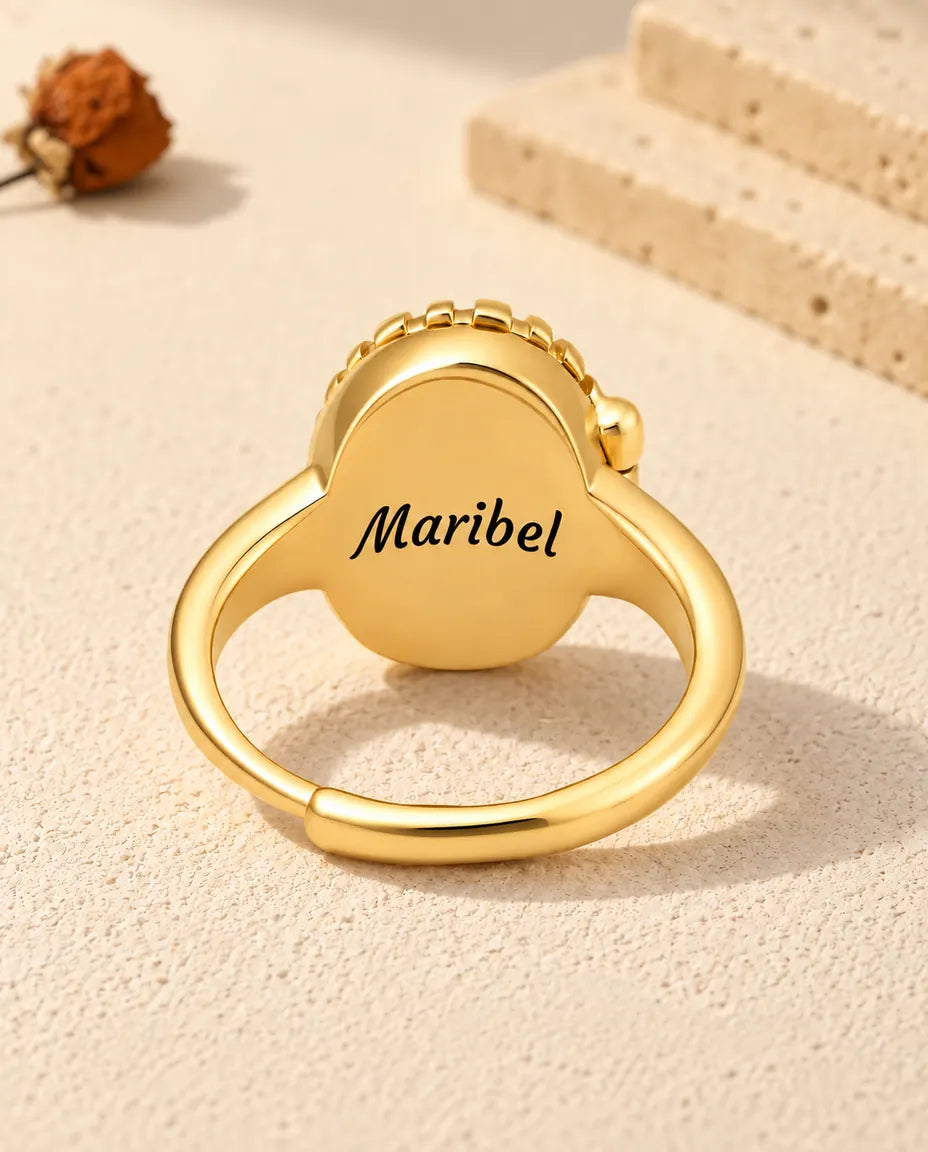 Back of the oval locket ring engraved with the name Maribel