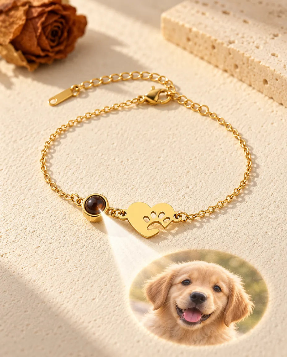 Light through the brown stone beside the gold tone paw heart projects a round puppy photo onto the plaster