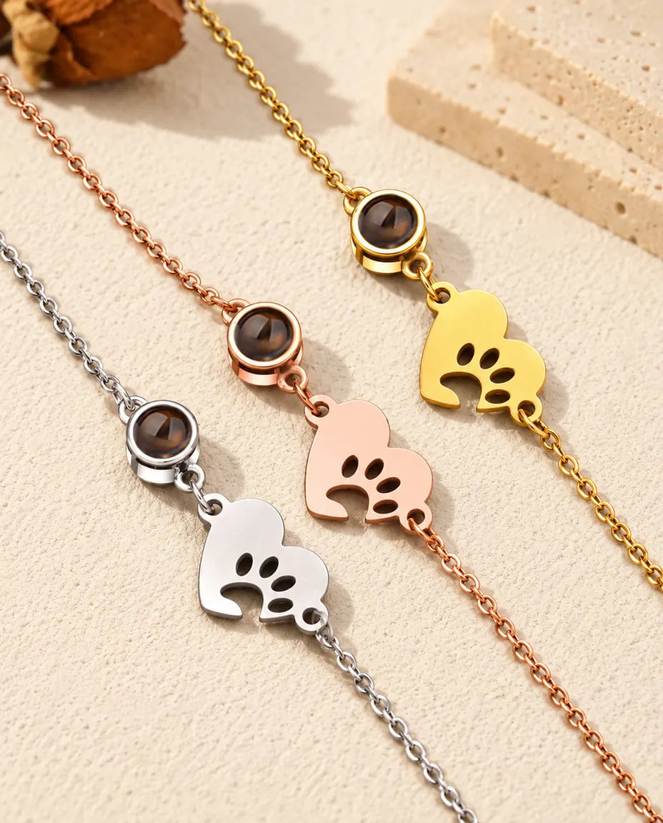 Close-up of three paw print heart tags and projection stones in each colour