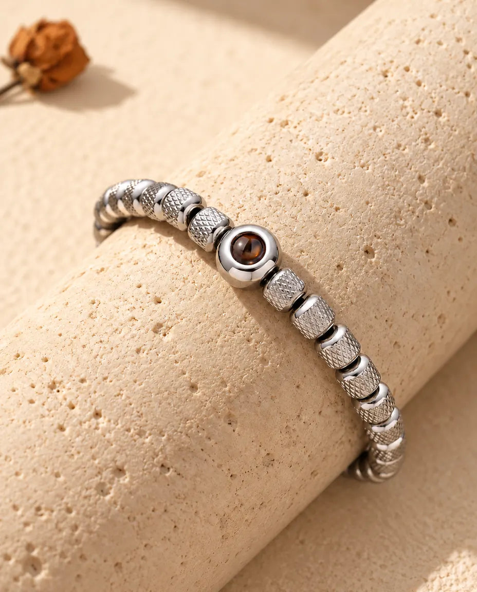Close-up of the silver tone round projection bead between knurled barrel beads