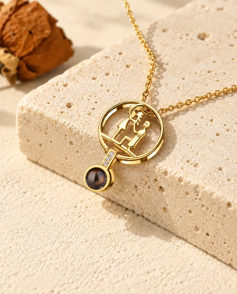 Personalised gold tone proposal photo projection necklace with a kneeling couple on travertine