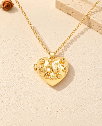 Front view of the gold tone sisters heart locket showing the lid design and side hinge